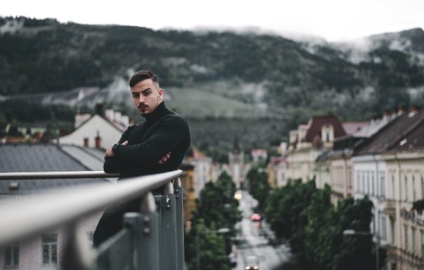 Daniel on a balcony overlooking a town