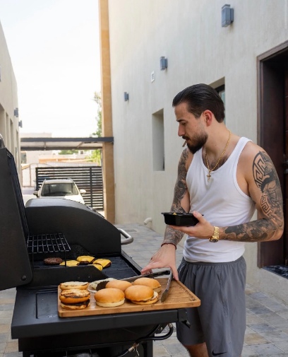 Daniel at a barbecue in a tank top